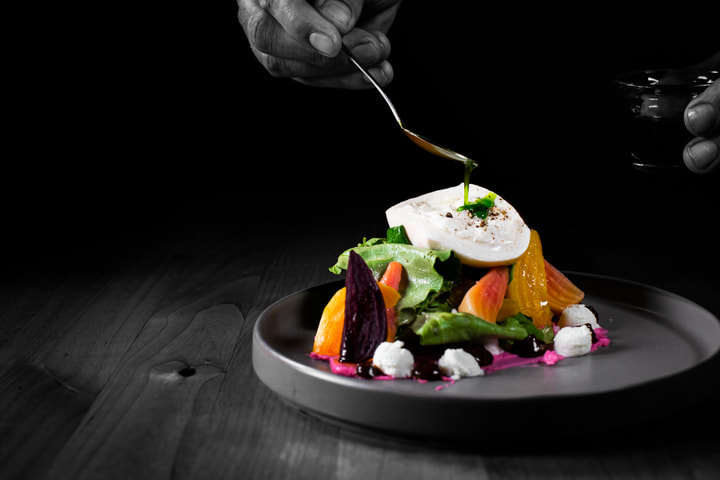 Dressing drizzled over a burrata salad