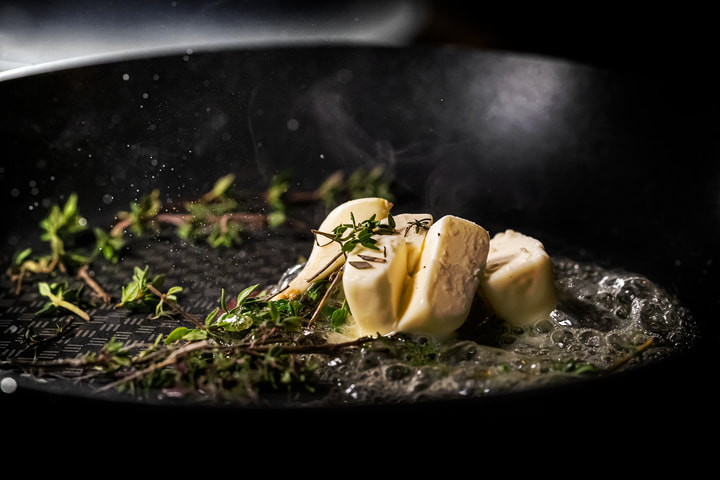 Thyme and garlic in a hot pan