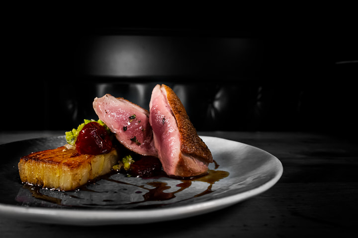 Sliced duck breast on a white plate