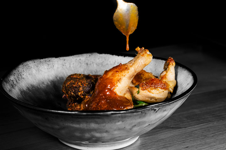 Sauce poured over roast hen in a bowl