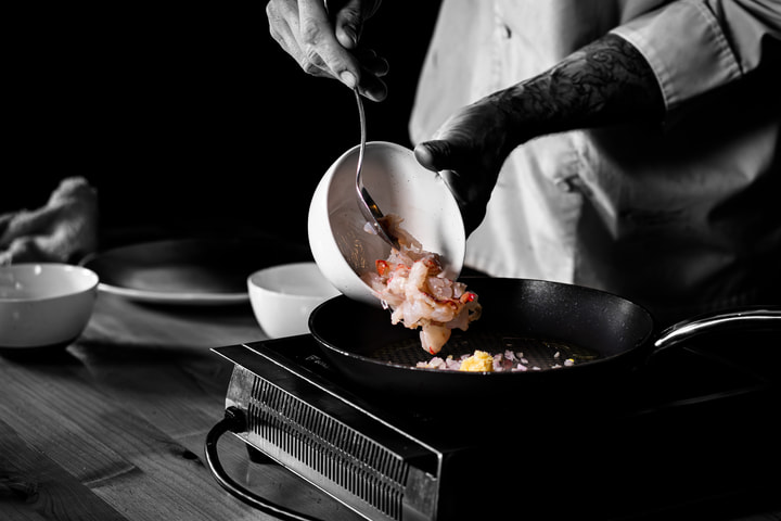 Chef pouring into a pan on the stove