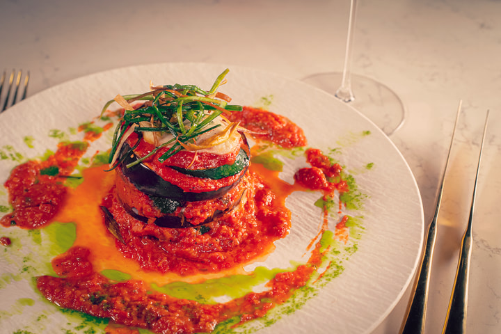 Layered stack with red pepper sauce