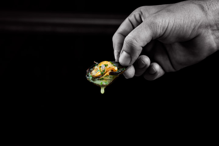 Hand holding a single bite on a spoon