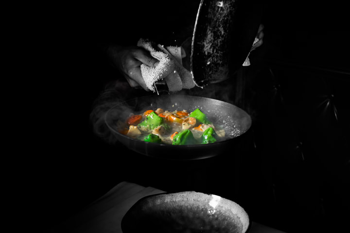 Vegetables cooking in a dark pan