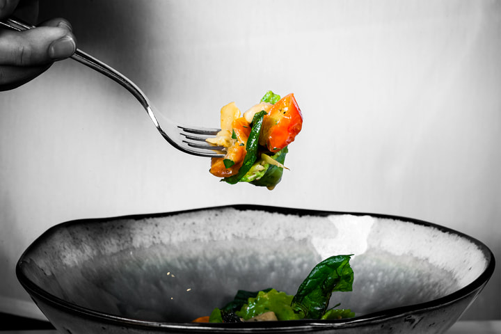 Fork lifting pasta above a bowl