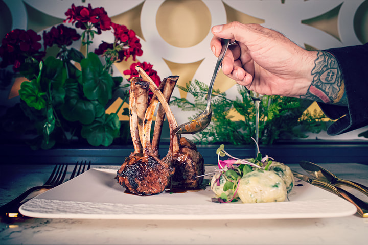 Hand plating a rack of lamb