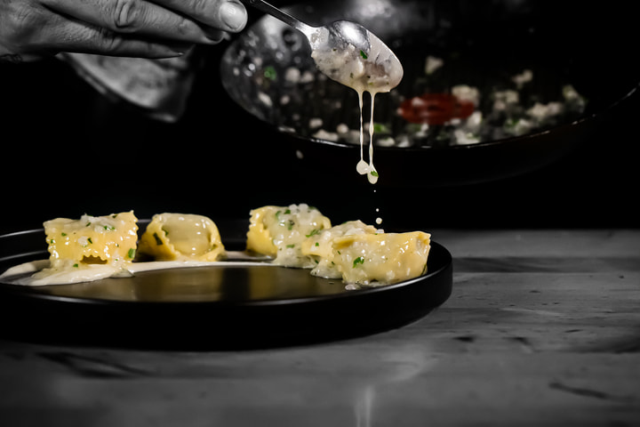 Sauce poured over plated pasta