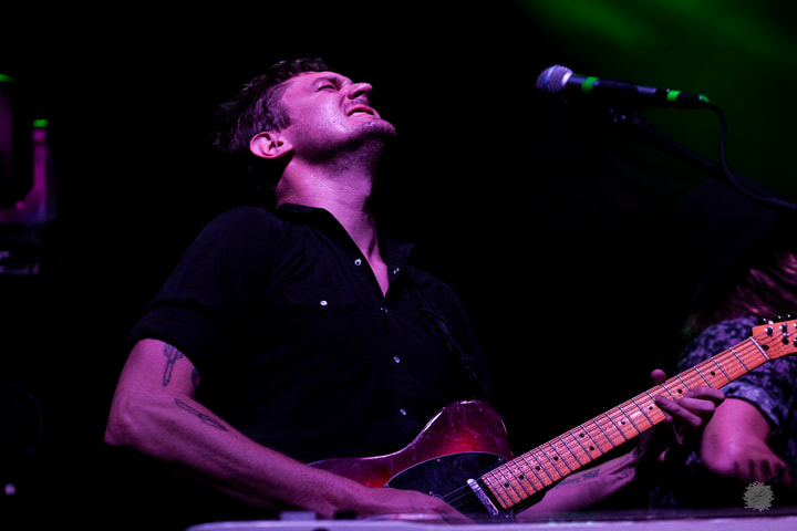 Guitarist looking up while playing