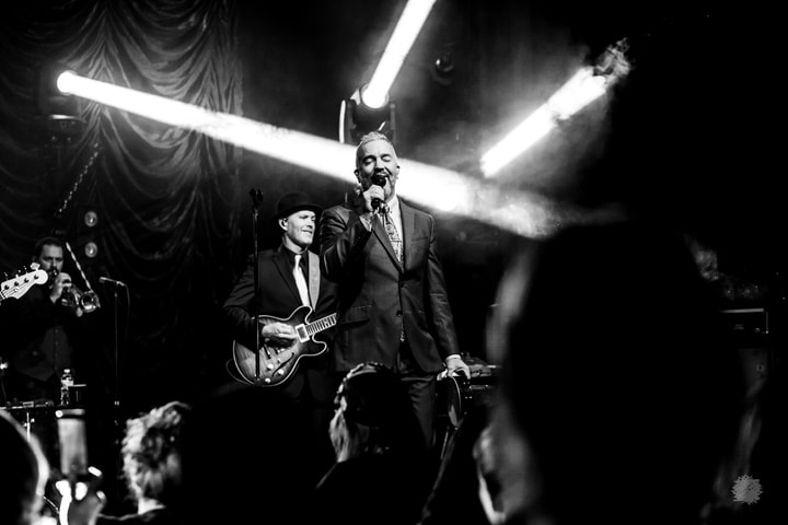Band under bright beams, black and white